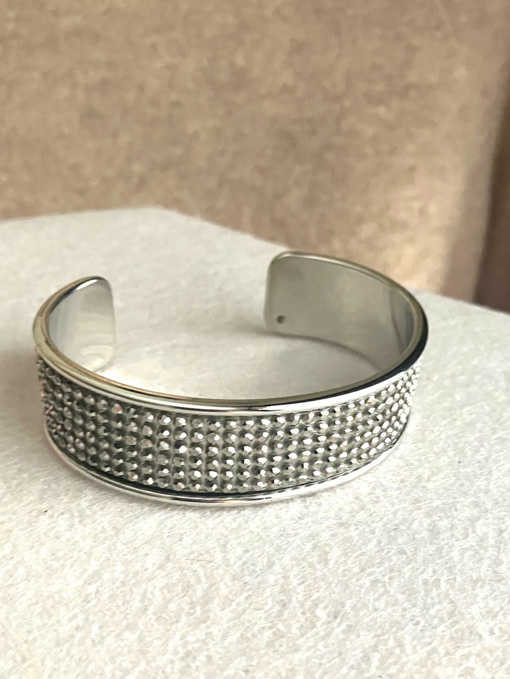 Silver cuff studded with metallic rhinestones